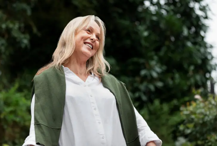 Elderly woman smiling outdoors