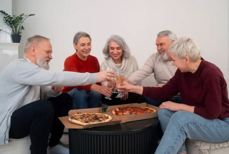 Elderly friends sharing a meal together