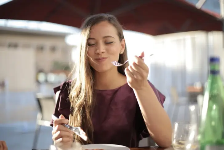 Solo Female Traveler Trying Local Cuisine.
